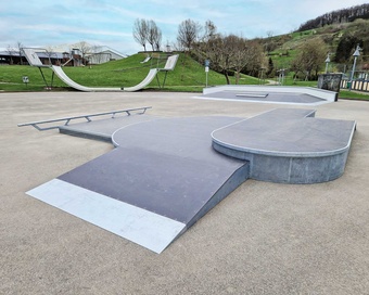 Panoramic view of Lauchringen skatepark with a halfpipe in the background and ramps in the foreground.
