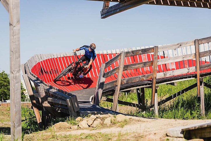 Biker rides artificial curve downhill
