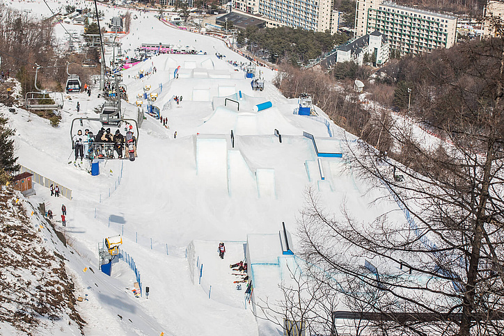 Slopestyle Pyeongchang mit Sessellift und Hochhäusern im Hintergrund