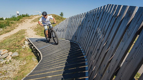 Biker hits obstacle towards camera