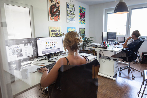 Two people in the office of the marketing department