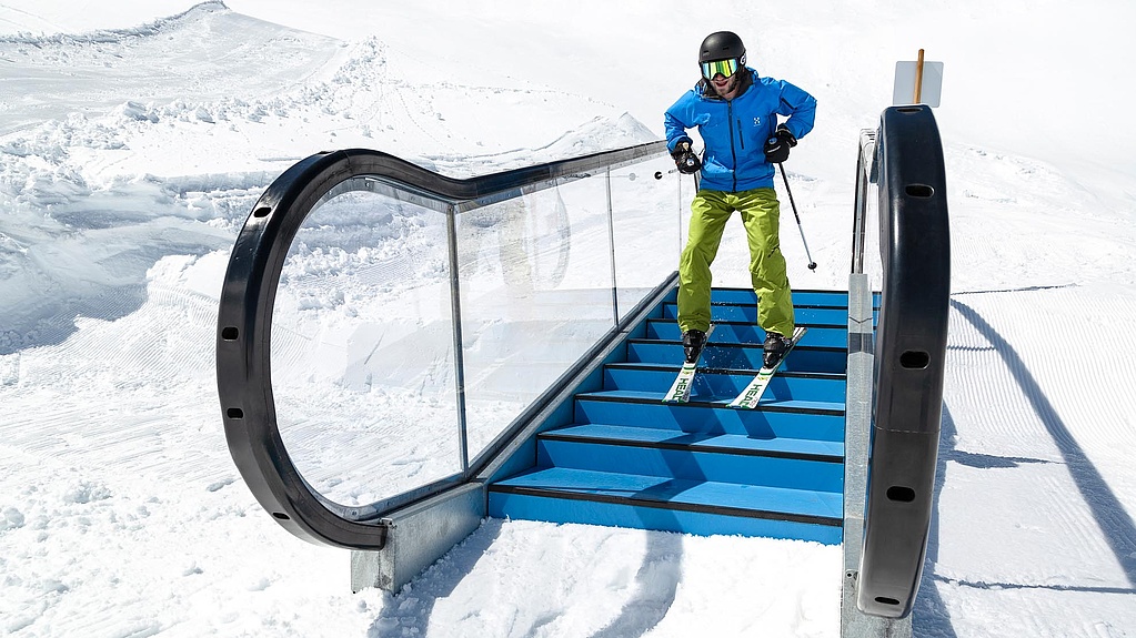 Skier goes downhill on escalator