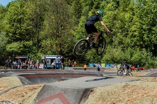 Child jumps with bike on a pump track 