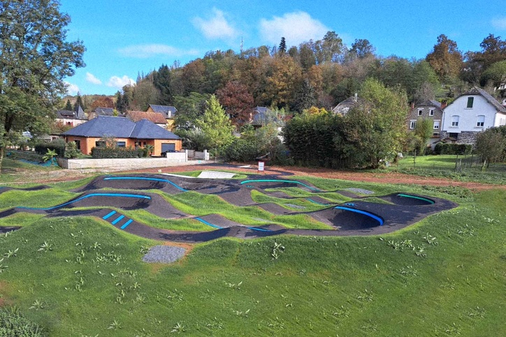Completed Objat pump track embedded in green surroundings