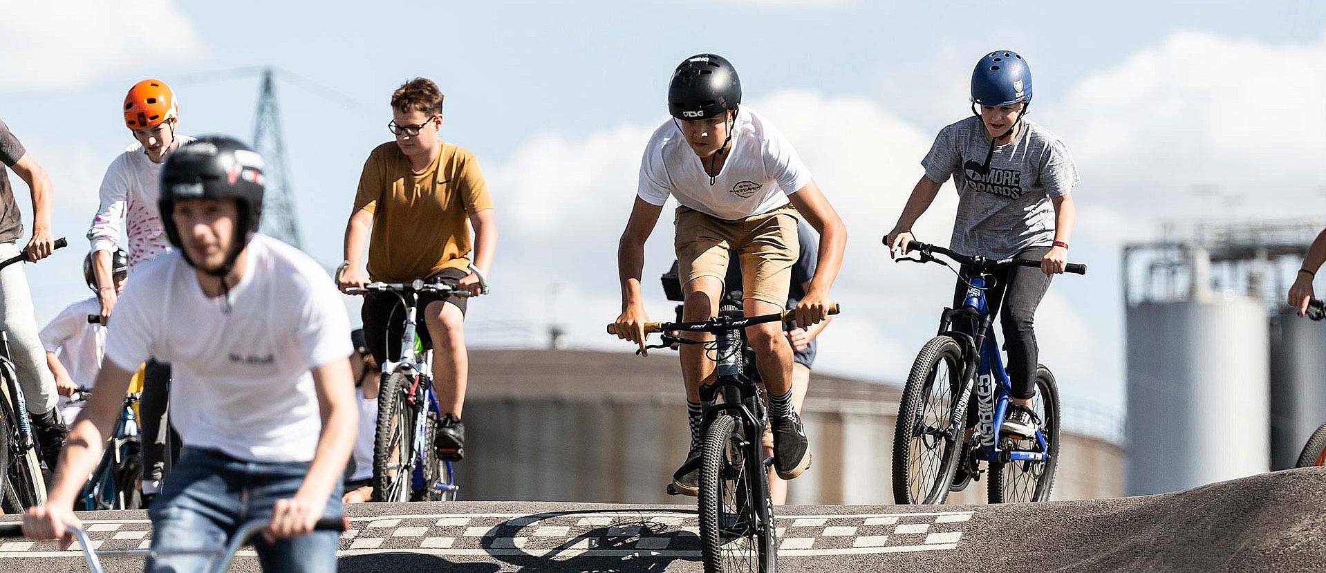 Group of teenagers riding on the pump track