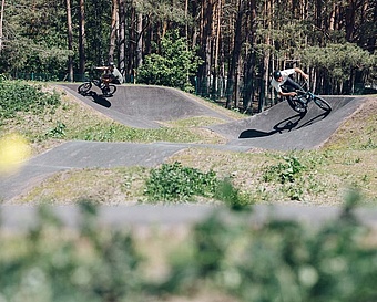 Two BMX riders at pump track Eberswalde