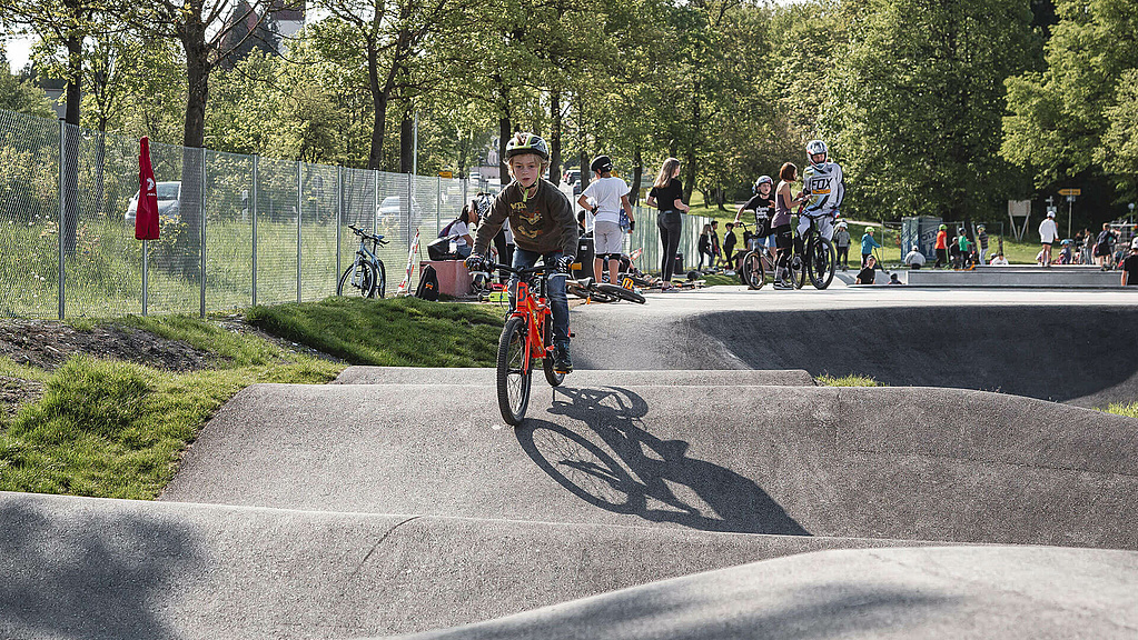 Boy with bike in pump track Füssen