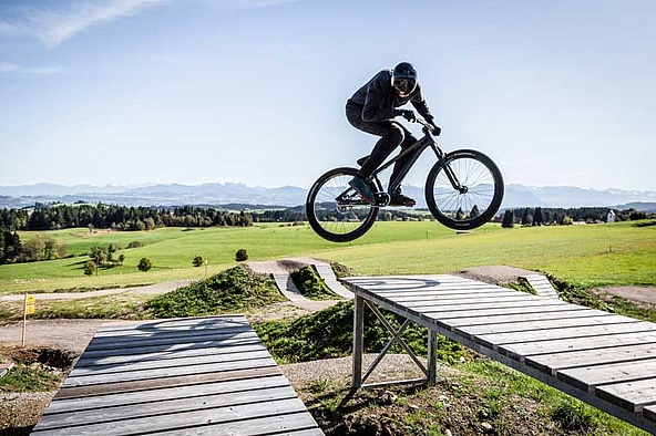 Biker jumps over drop