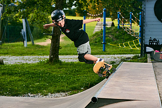 Boy doing a skateboard trick on a ramp