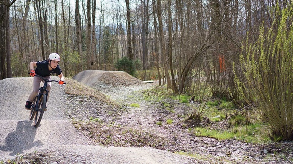 Mountain biker carving turn on pump track in Sonthofen bike park