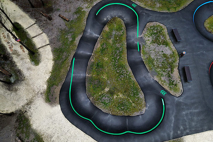 Aerial view of Pumptrack Audenge with winding asphalt tracks in the forest area