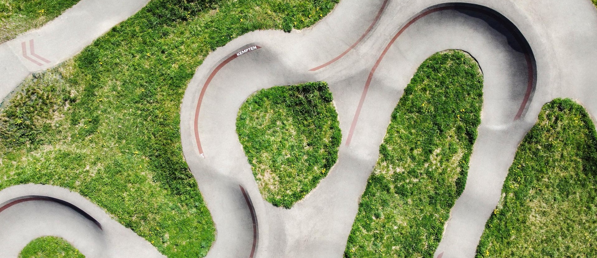 Aerial view of the pump track at Engelhaldepark Kempten next to the climbing hall