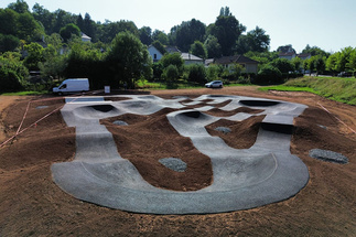 Pumptrack Objat im Bau mit asphaltierten Lines und Erdhügeln