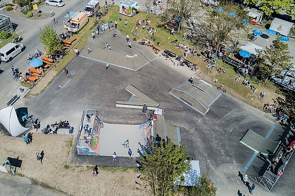Drone image of skatepark obstacles on an asphalt surface