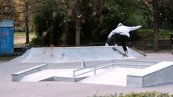 Skater jumping over the rail at Memmingen Skatepark