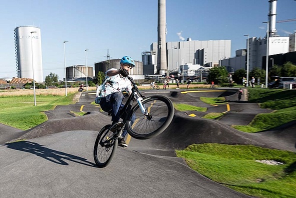 Cyclist doing a manual at the pump track in Linz
