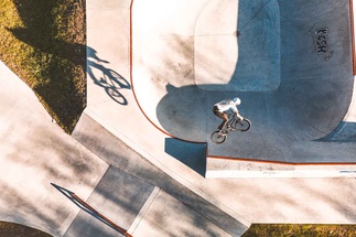 BMX rider in action on a steep concrete edge of the park in Samoëns.