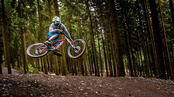 Biker jumps in a forest