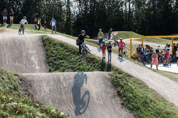 Mountain biker jumps over dirt jump