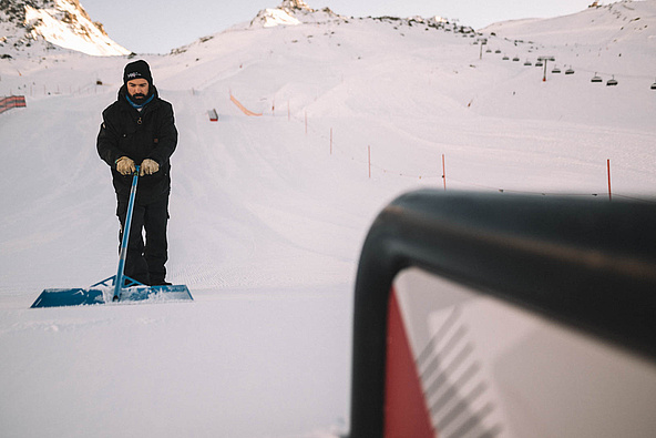 Snow park in Ischgl is shaped by hand at sunrise