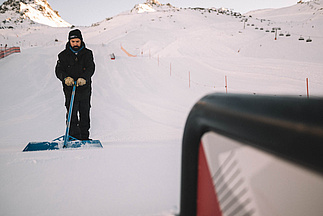 Snow park in Ischgl is shaped by hand at sunrise