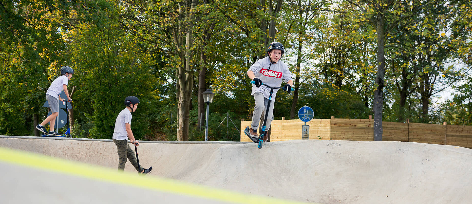 Boy on scooter rides in skate park Hennef