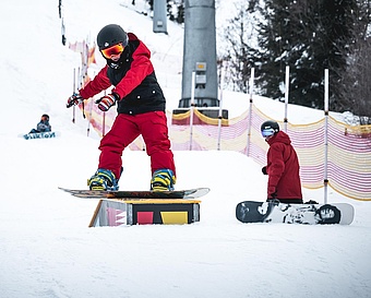 Snowboard kid slides on box