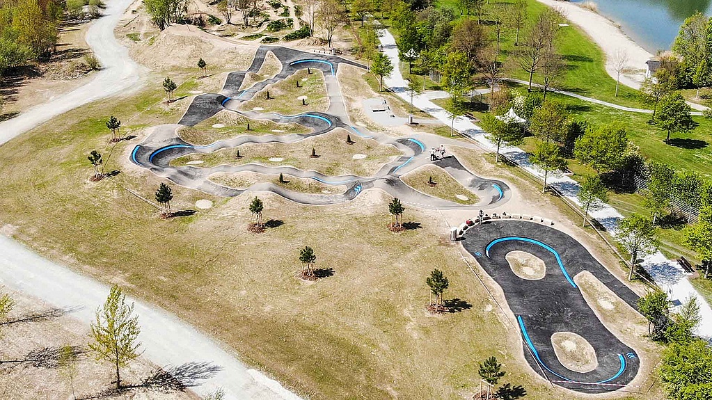 Aerial view of pump track Pocking next to the bathing lake