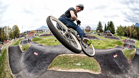 Man with bike makes a jump on jumptrack