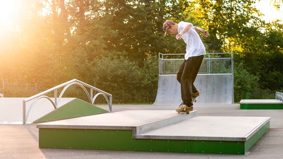 Sunset over Rampenpark Isny with skaters on the obstacles