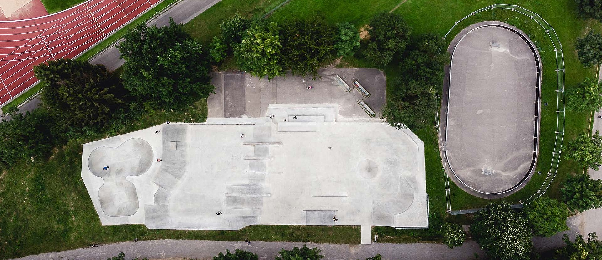 Drone image of skate park and sports field with green spaces