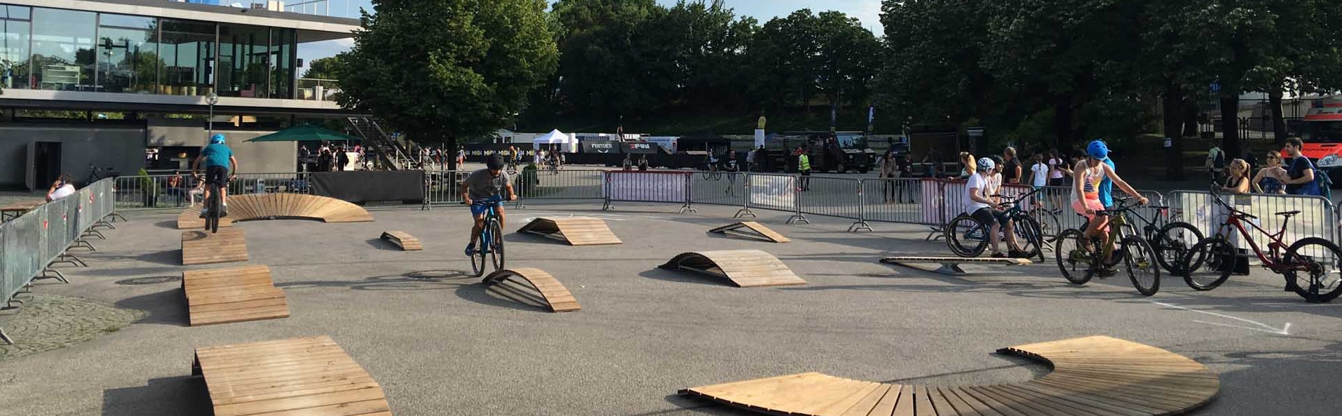 Various exercise elements on an asphalt square with trees