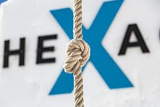 Rope with knot and Hexagon logo in the background