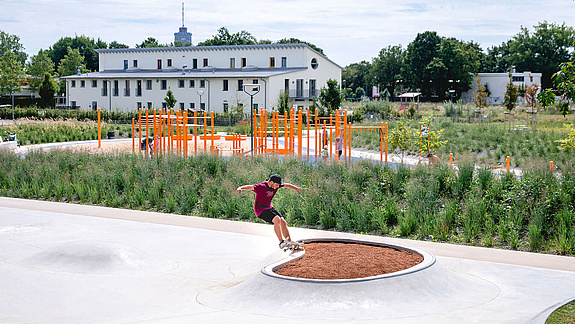 [Translate to Französisch:] Skater im Skatepark Reese Park Augsburg for einer Calisthenics Anlage