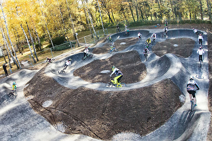 Pump track with many riders at a glance