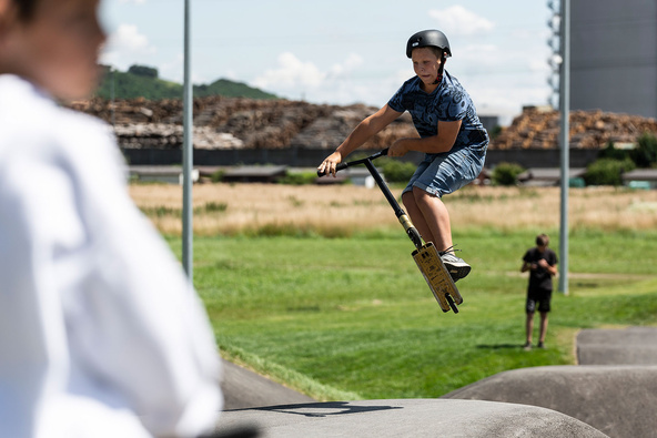 Child jumping with his scooter