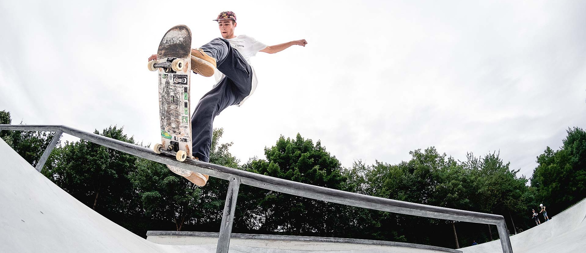 Skateboarder performing a trick on a rail in a skate park