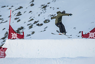 Skier jumps over ski jump