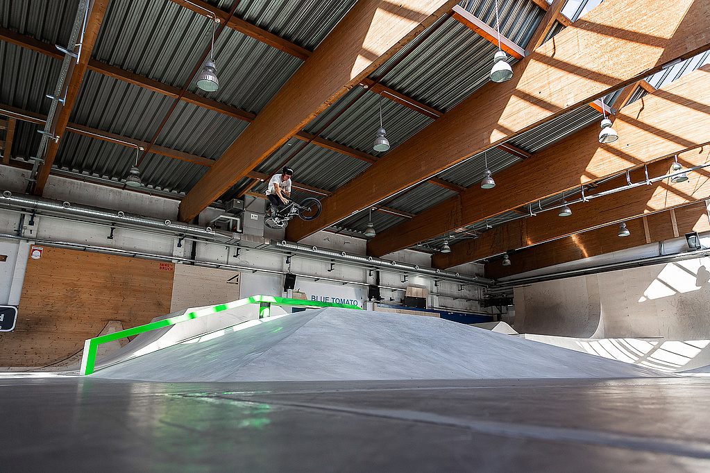 Skater does a trick in an indoor skate hall