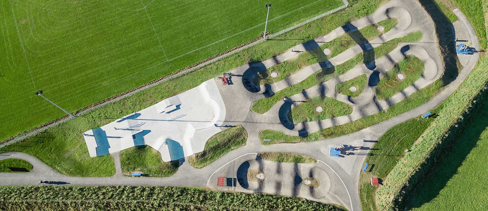 Drone view of Urban Sports Park Durach with skatepark, pumptrack and adjacent soccer field.