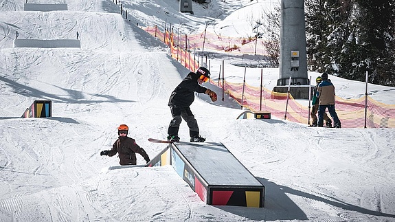 Boy with snowboard on a box