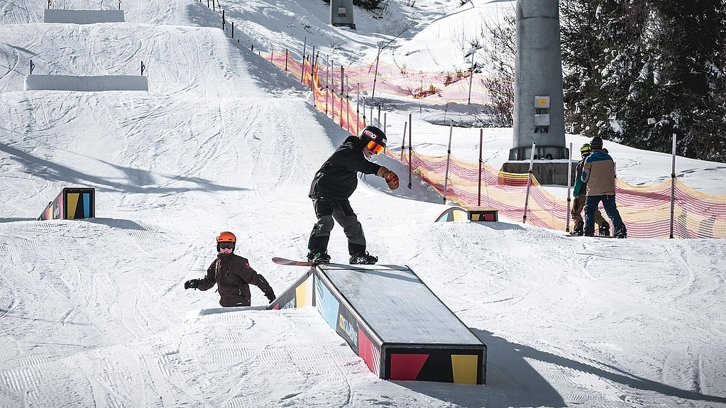 Boy with snowboard on a box
