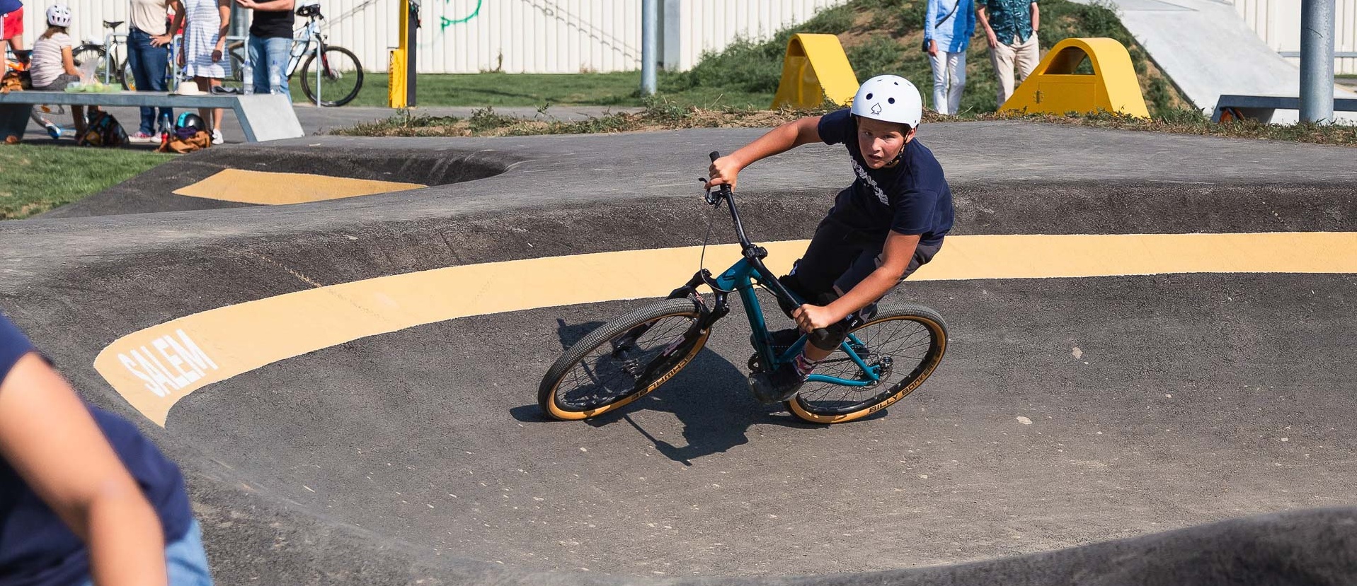 Boy rides dirt bike on a pump track