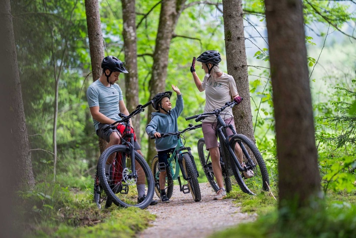 Family on bikes in the forest