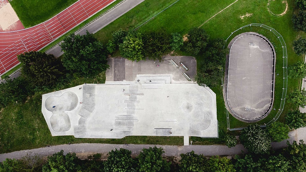 Drone image of skate park and sports field with green spaces
