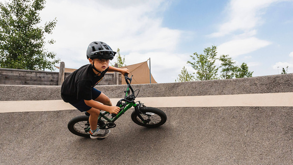 Junge fährt mit seinem Rad in einer Kurve im Pumptrack Gunskirchen