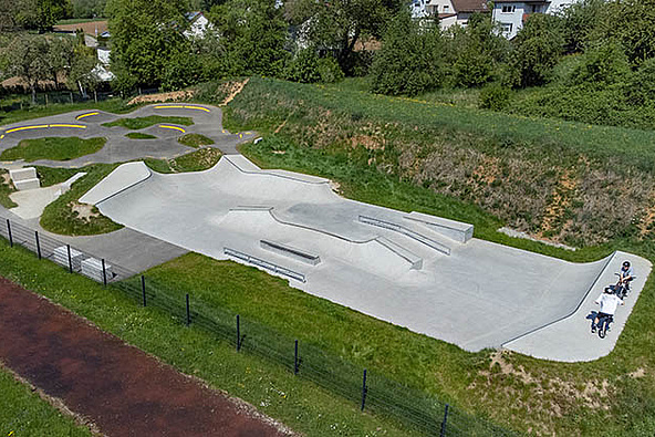 Concrete skatepark with street elements next to the pump track in Uhingen