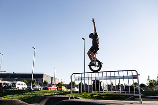 Unicyclists on the pump track