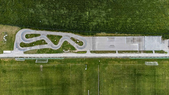 Wide view of Urban Sports Park Uffing with fields in the background