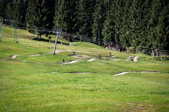 Trail schlängelt sich am Waldrand unter Lift hindurch